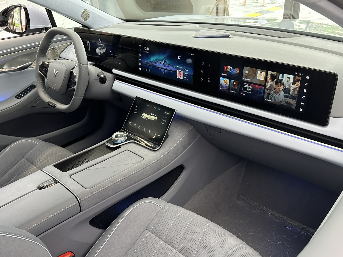 Wide digital dashboard and touchscreen control panel in a modern car interior