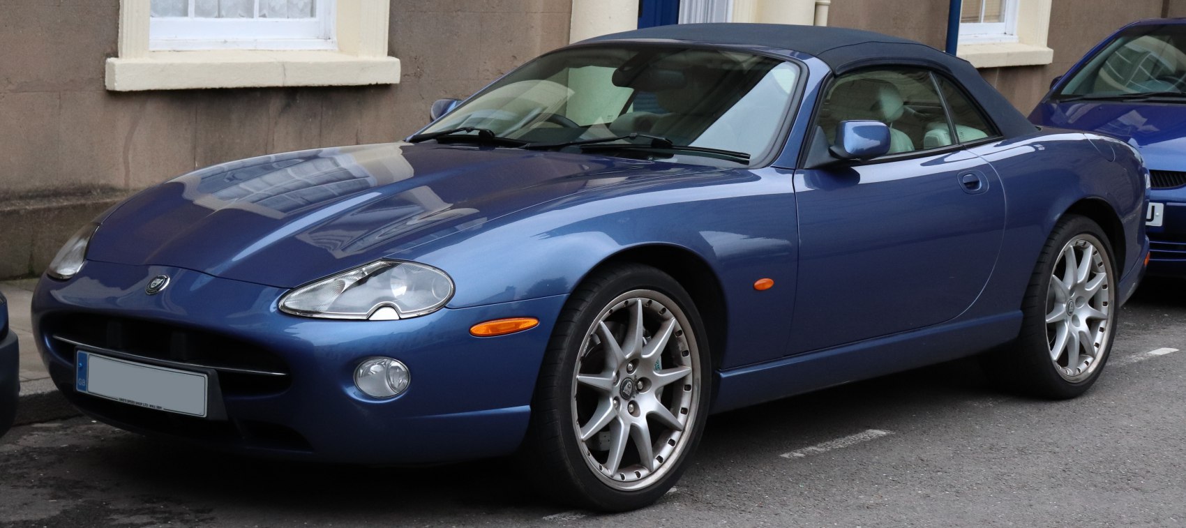 Sleek convertible with closed soft top and alloy wheels