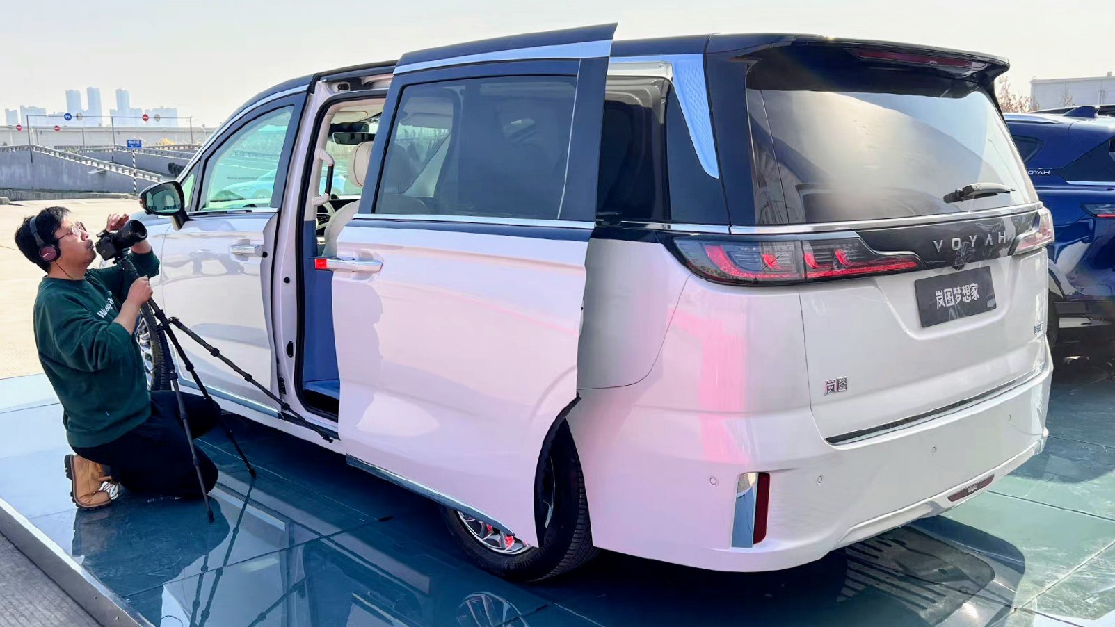 White minivan with sliding rear door and sleek rear design