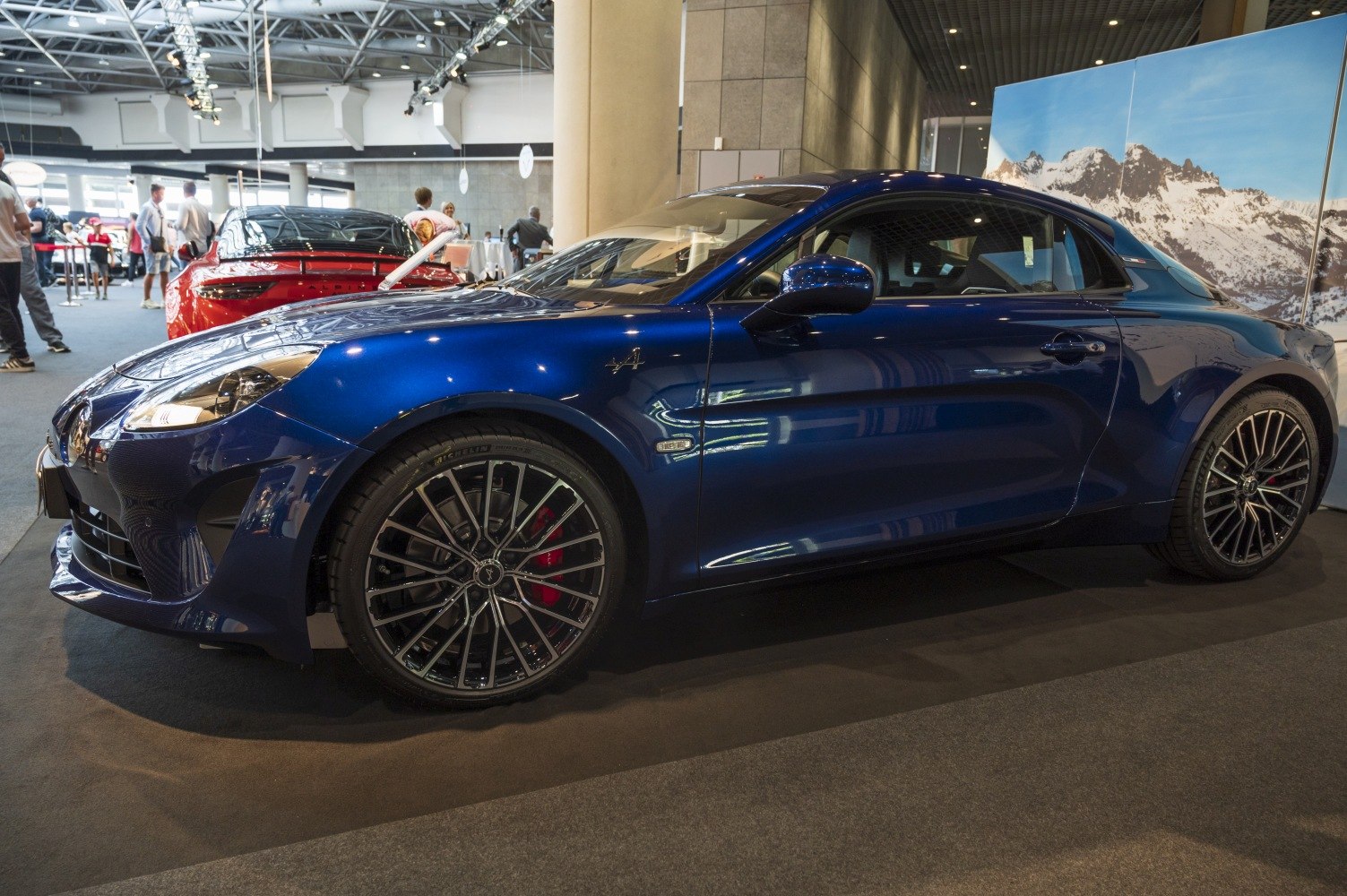 Blue coupe with sporty alloy wheels and aerodynamic body