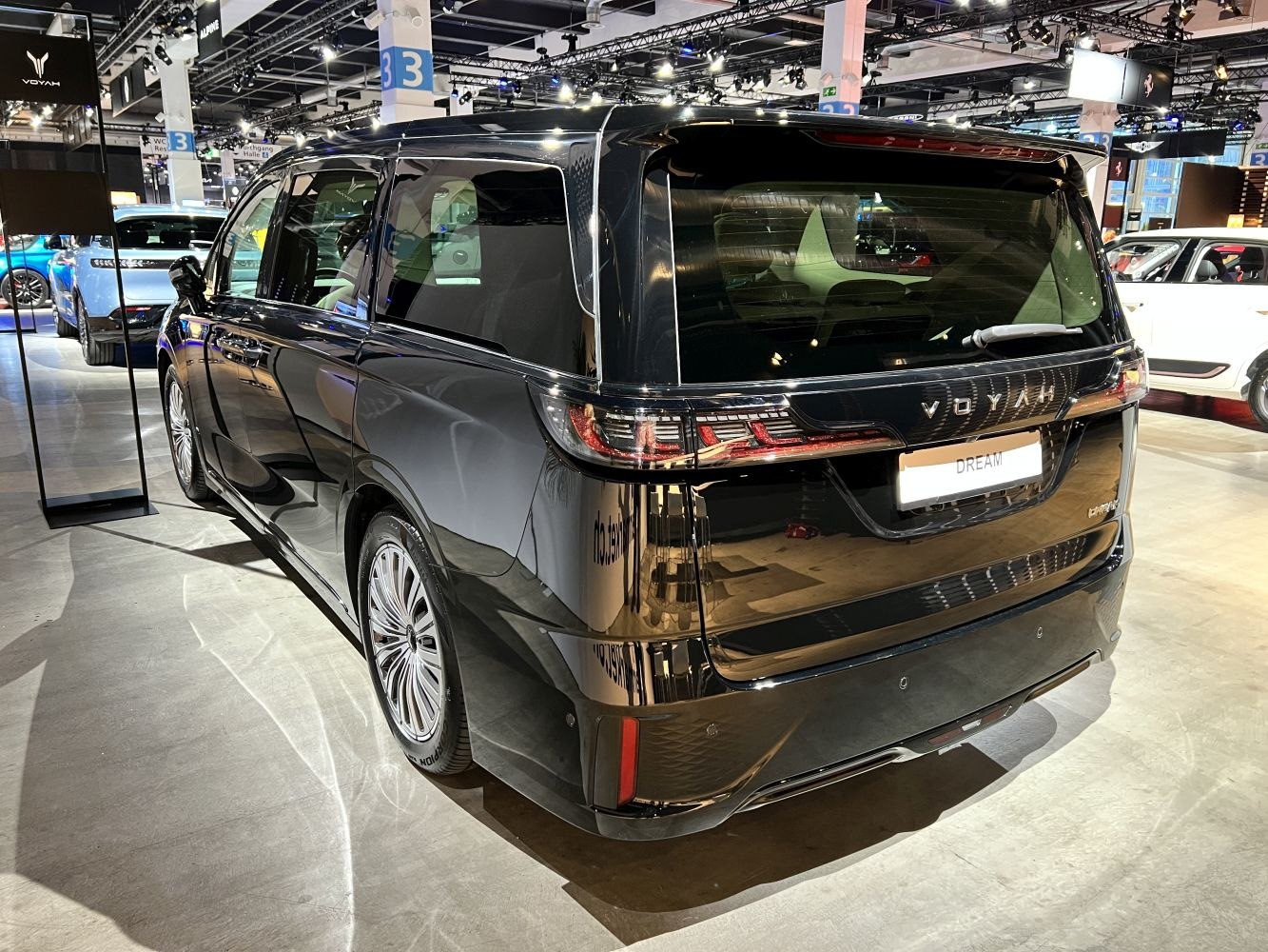 Rear view of a sleek MPV with designer tail lights and tinted windows