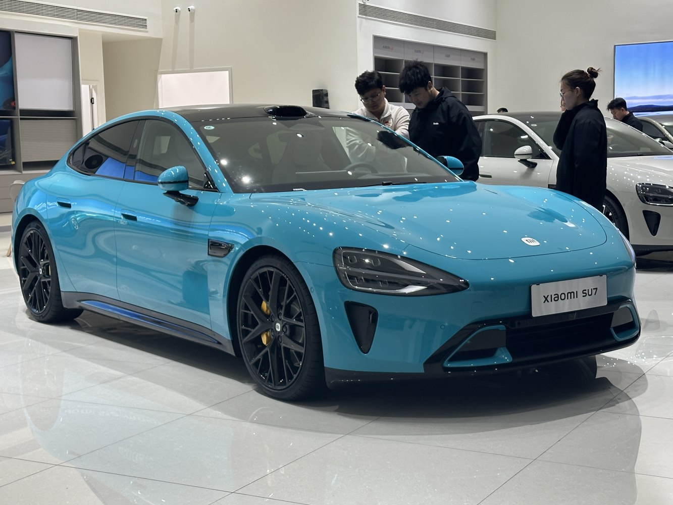 Sleek electric sedan with aerodynamic design and black alloy wheels