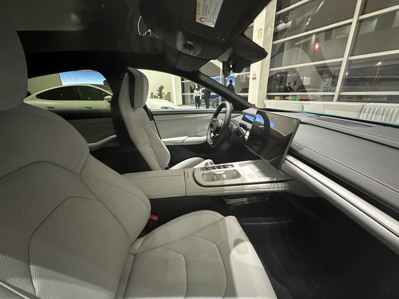 Premium front seats and large digital touchscreen dashboard in car interior