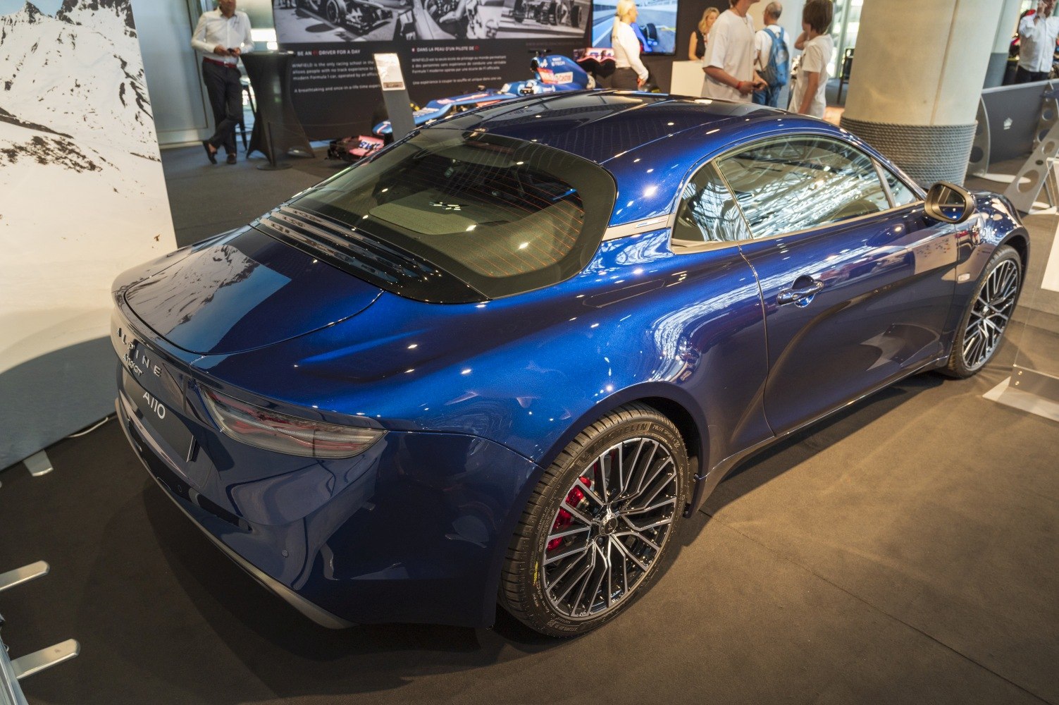 Rear and side view of sleek sports coupe with alloy wheels and tinted rear window