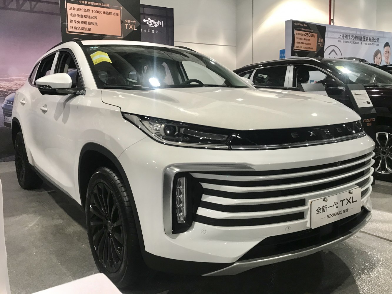 Close-up of sleek LED headlights and horizontal grille on a white SUV front