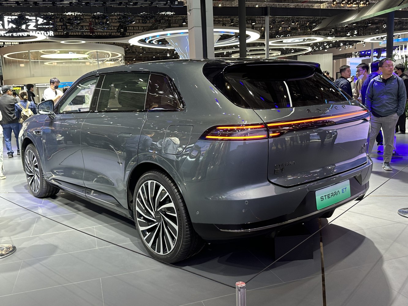 Rear view of an electric SUV with continuous LED light bar and large multi-spoke alloy wheels
