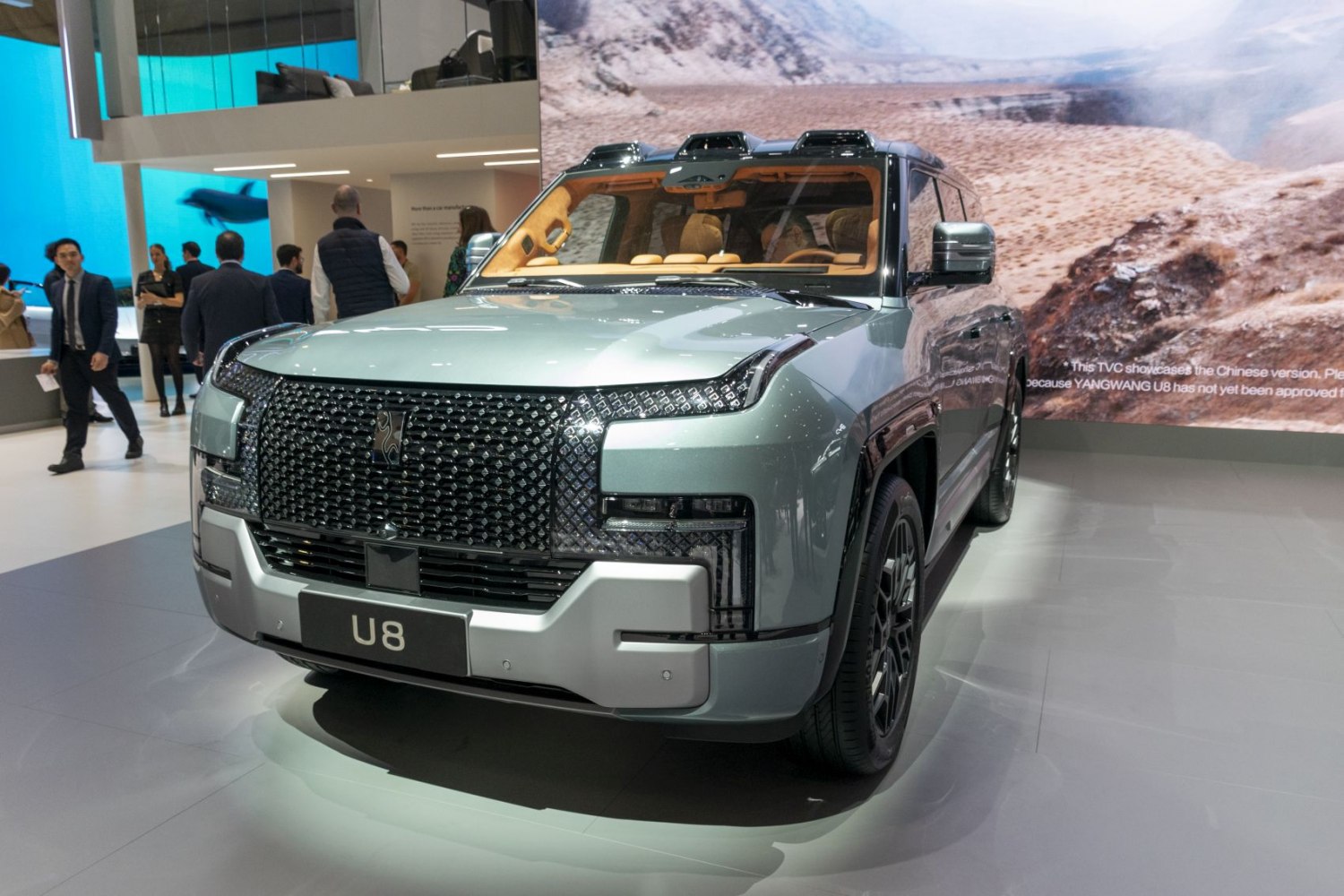 Bold front grille and luxury SUV interior with visible roof sensors