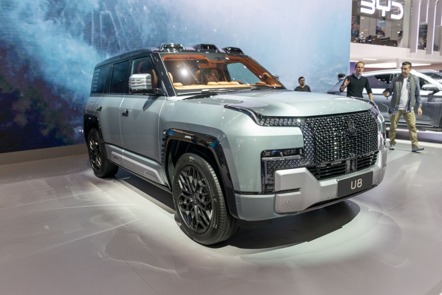 Front angled view of SUV with unique grille and rooftop lights