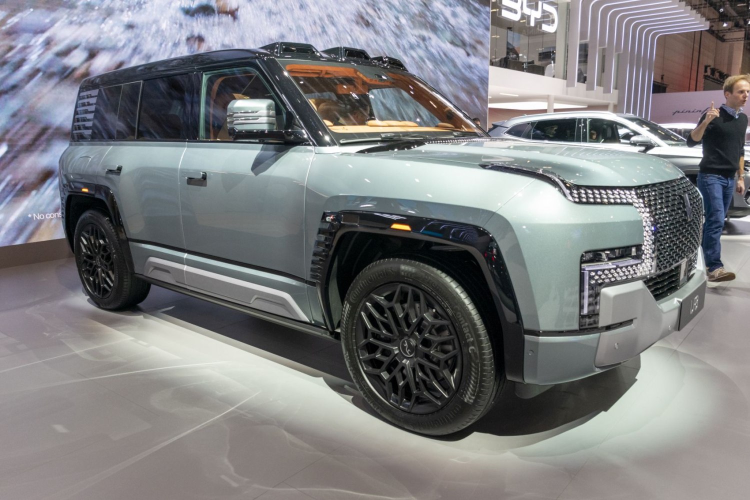 Futuristic front grille and LED lights with black alloy wheels on modern SUV.