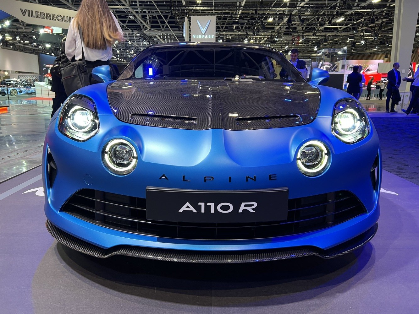 Front view with circular LED headlights and carbon fiber hood