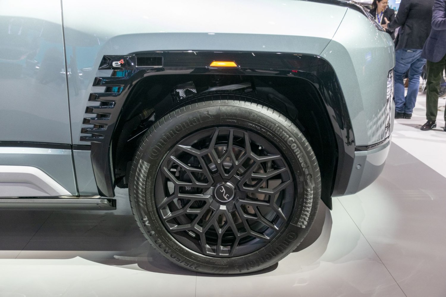 Close-up of wheel and fender with intricate alloy rim and tire