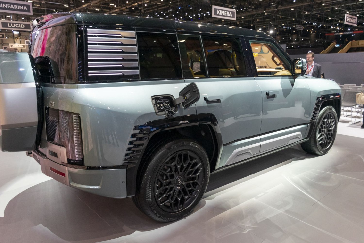 Electric SUV side view with rear vent design and open charging port