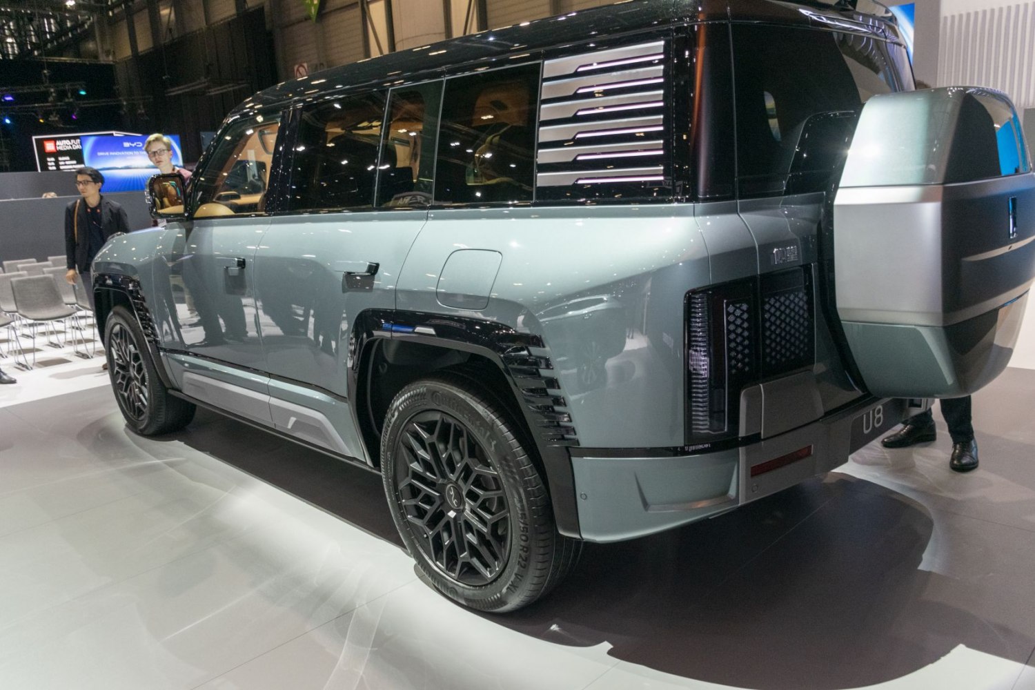 Rear side view of luxury SUV with unique wheels and spare tire