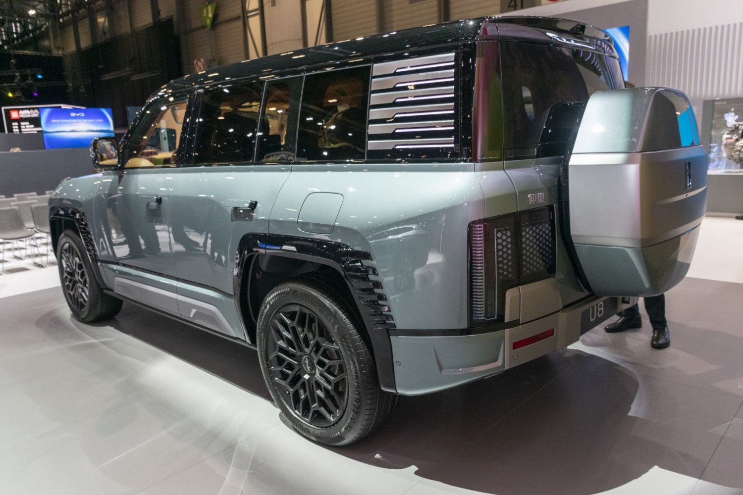 Rear side profile of a luxury SUV with distinct spare wheel case and alloy wheels