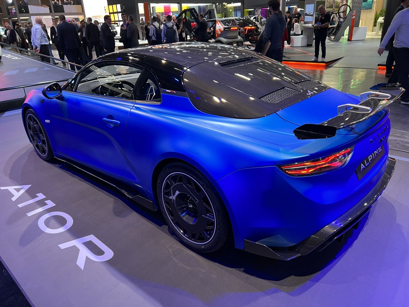 Blue sports coupe with carbon fiber roof and prominent rear spoiler