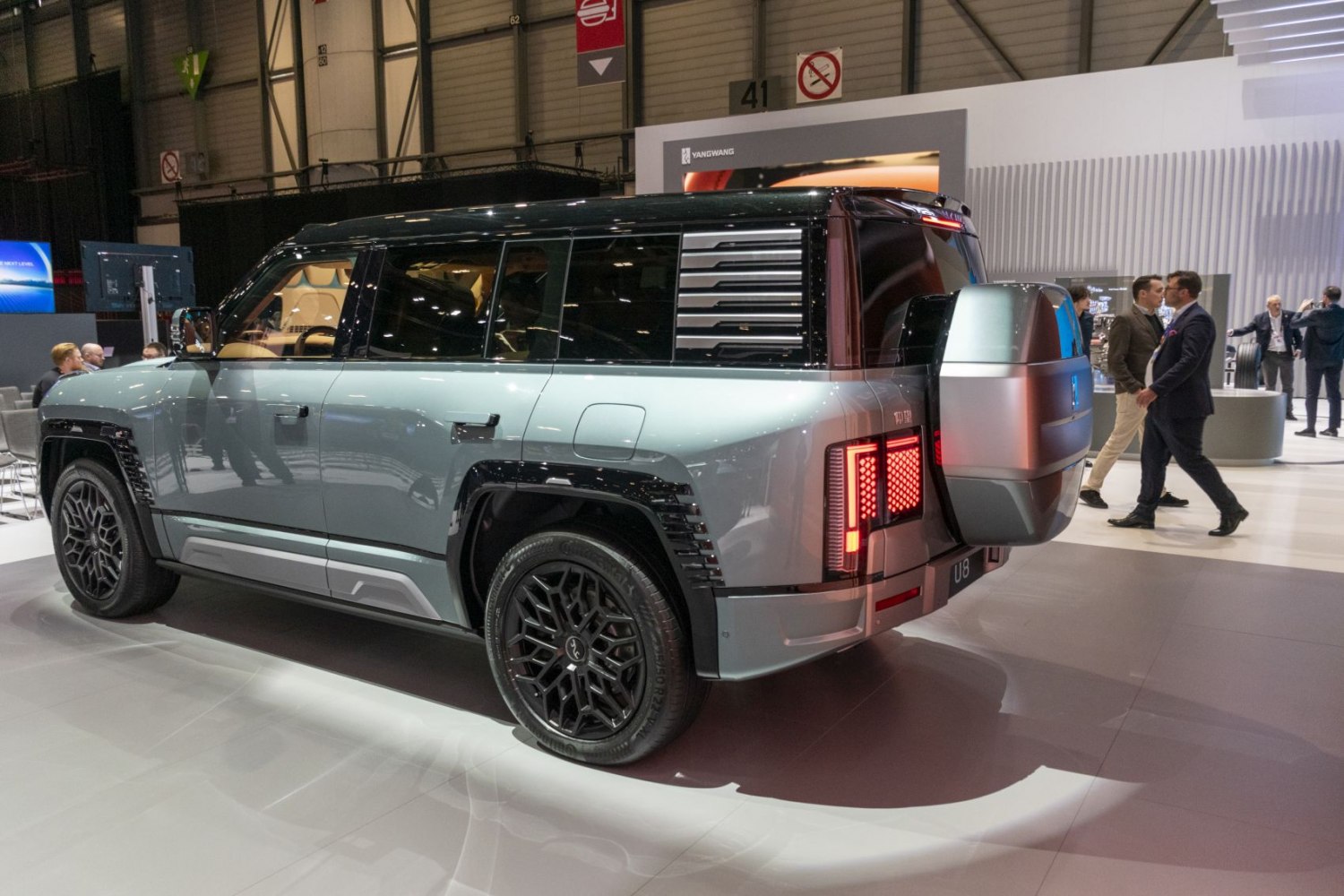 Rear and side view of an SUV with spare tire mount and futuristic wheels