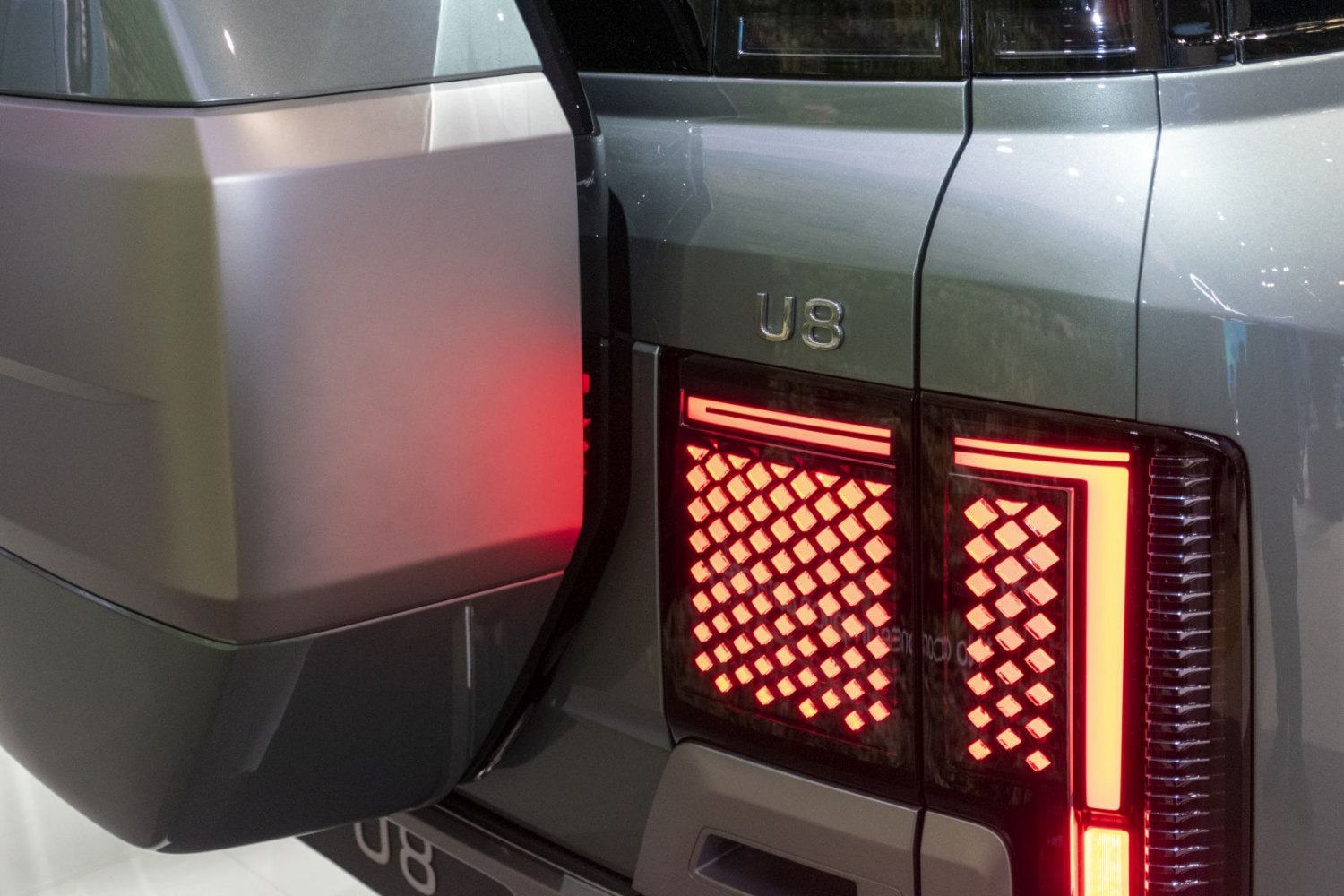 Rear tail light with unique illuminated pattern and U8 badge