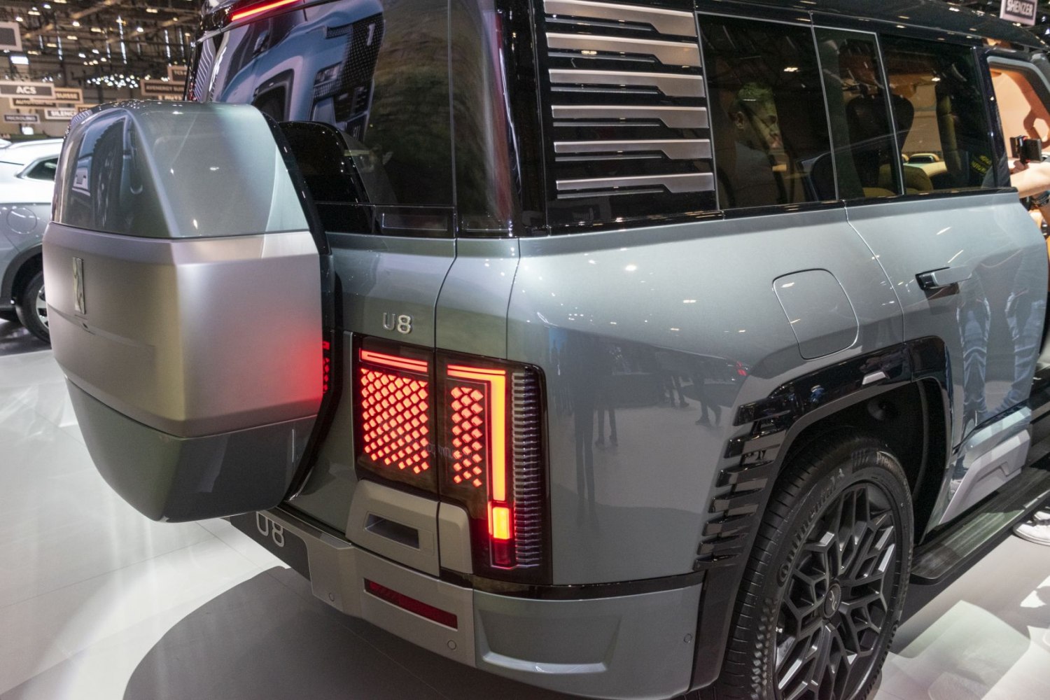 Rear view with rear-mounted spare wheel and LED tail lights.