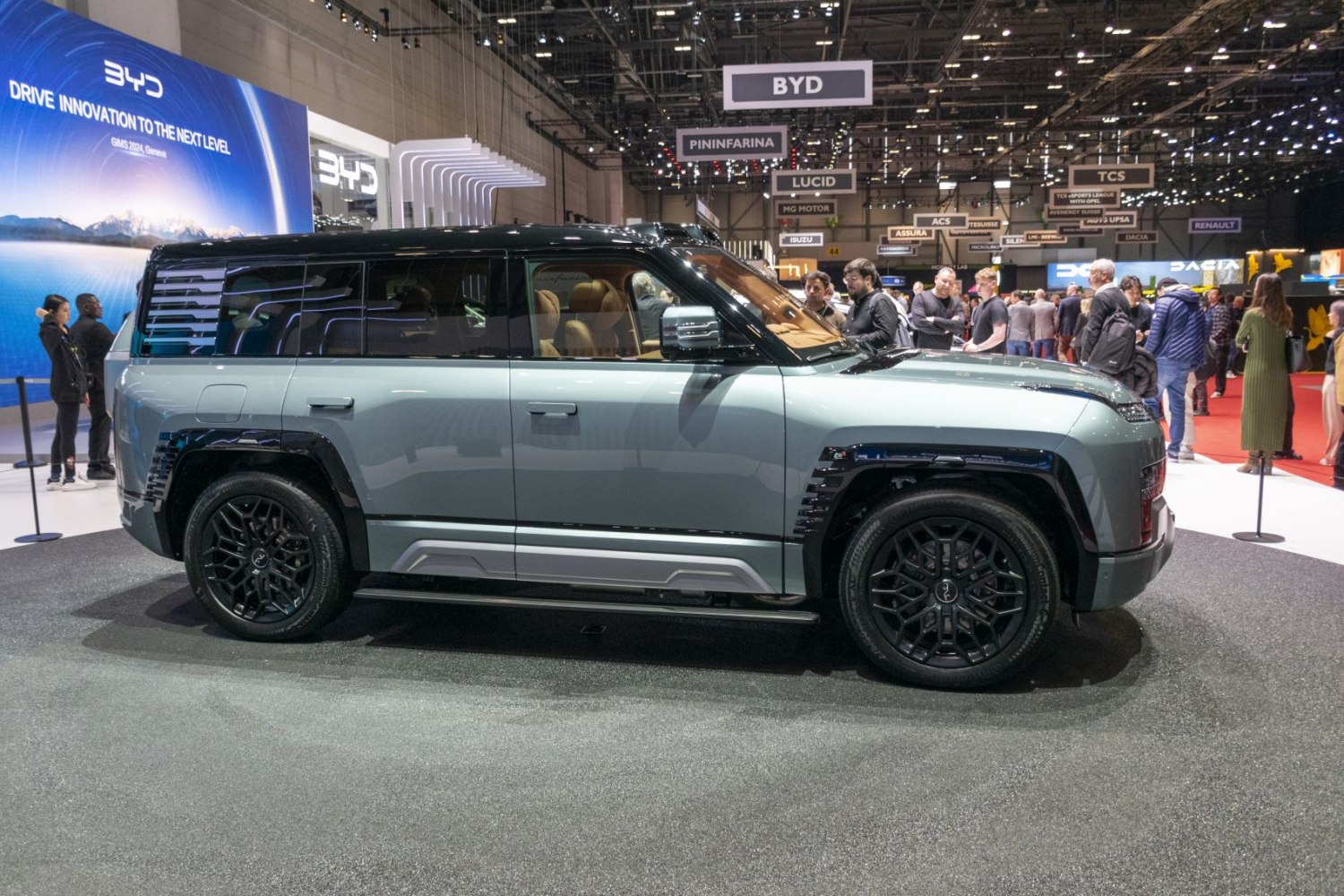 Side profile of SUV with black multi-spoke wheels.