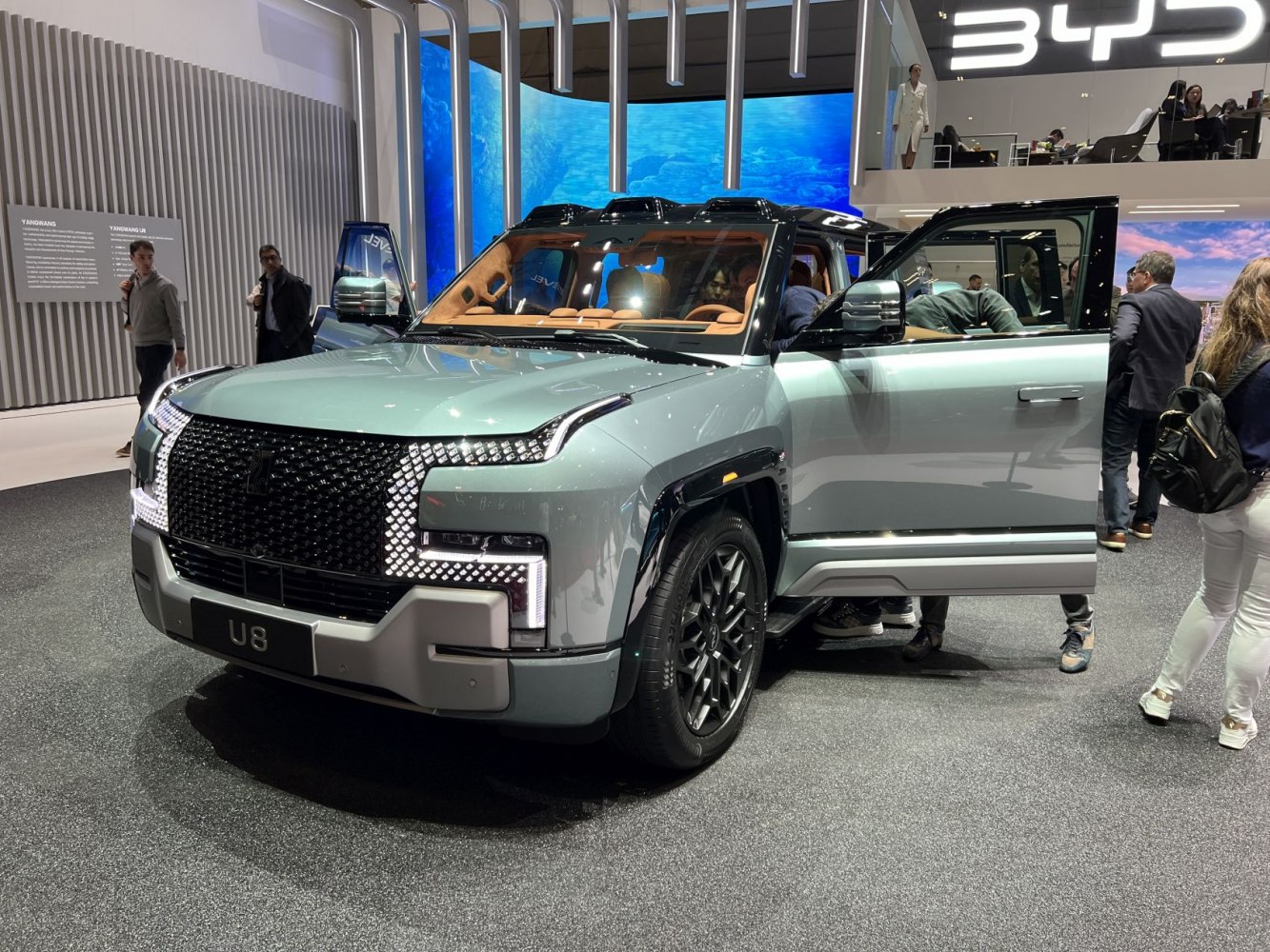 LED-lit front grille and spacious luxury SUV interior with open doors