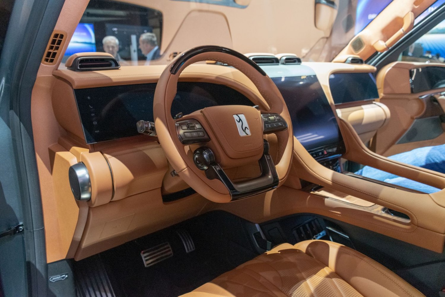 Luxury tan leather steering wheel and digital dashboard display