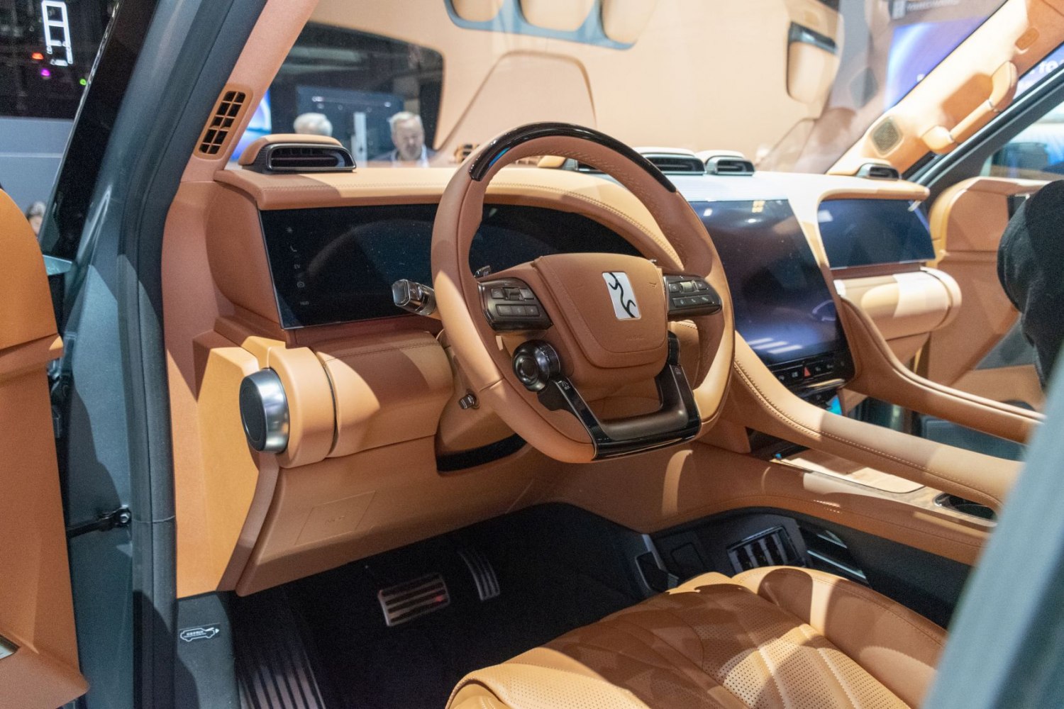 Luxury steering wheel and digital dashboard with tan leather interior