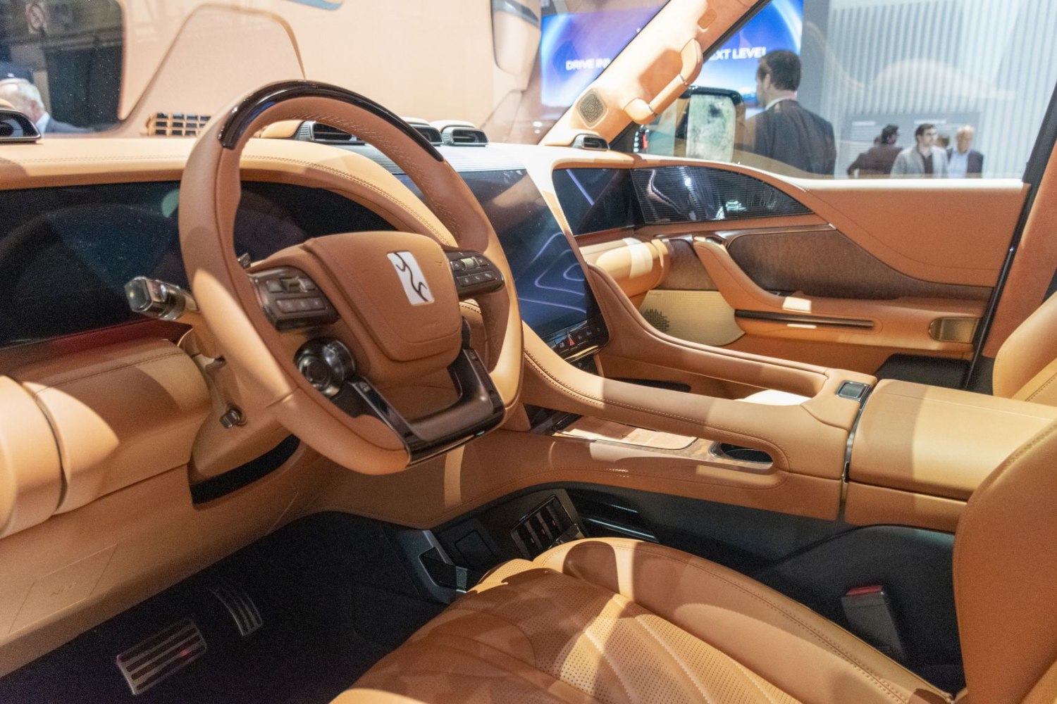 Luxury digital dashboard and unique steering wheel in tan leather