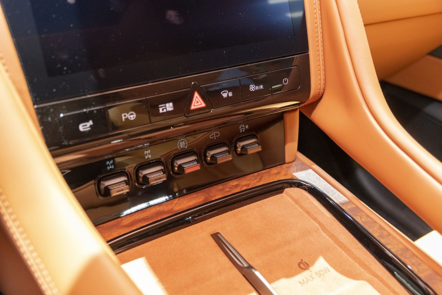 Center console with control switches, touchscreen, and leather upholstery