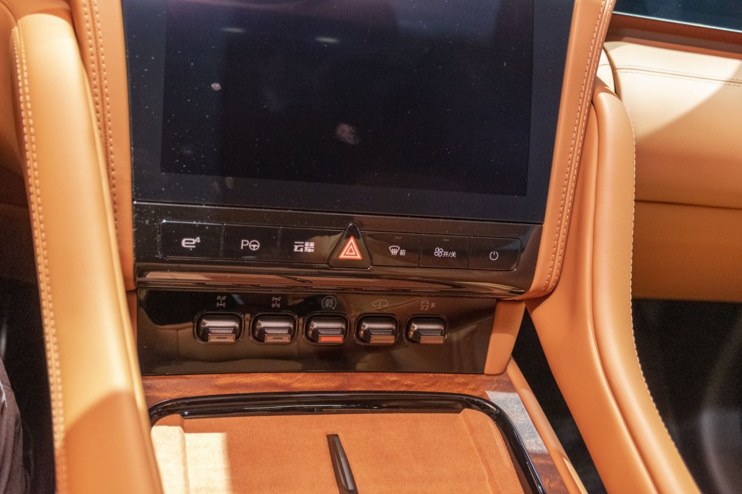 Center console touchscreen and control buttons with tan leather trim