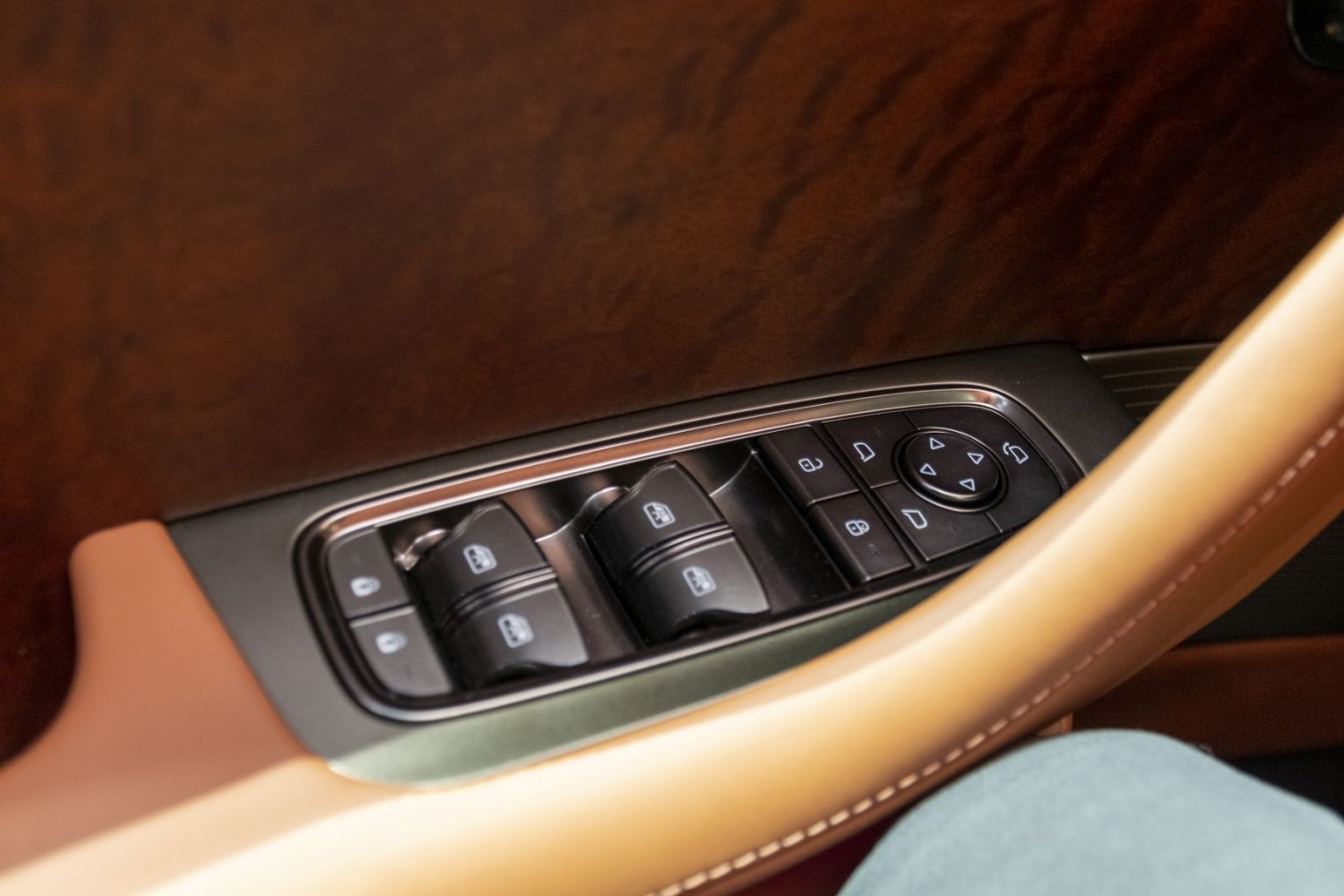 Car window and mirror control panel with wood and leather trim