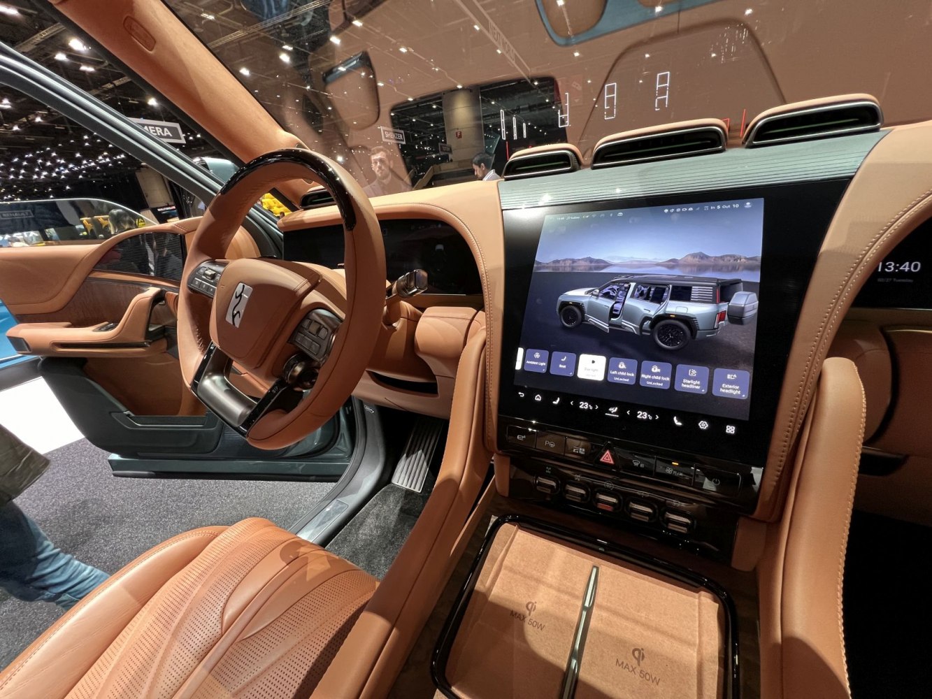 Luxury car interior with large digital touchscreen and brown leather upholstery