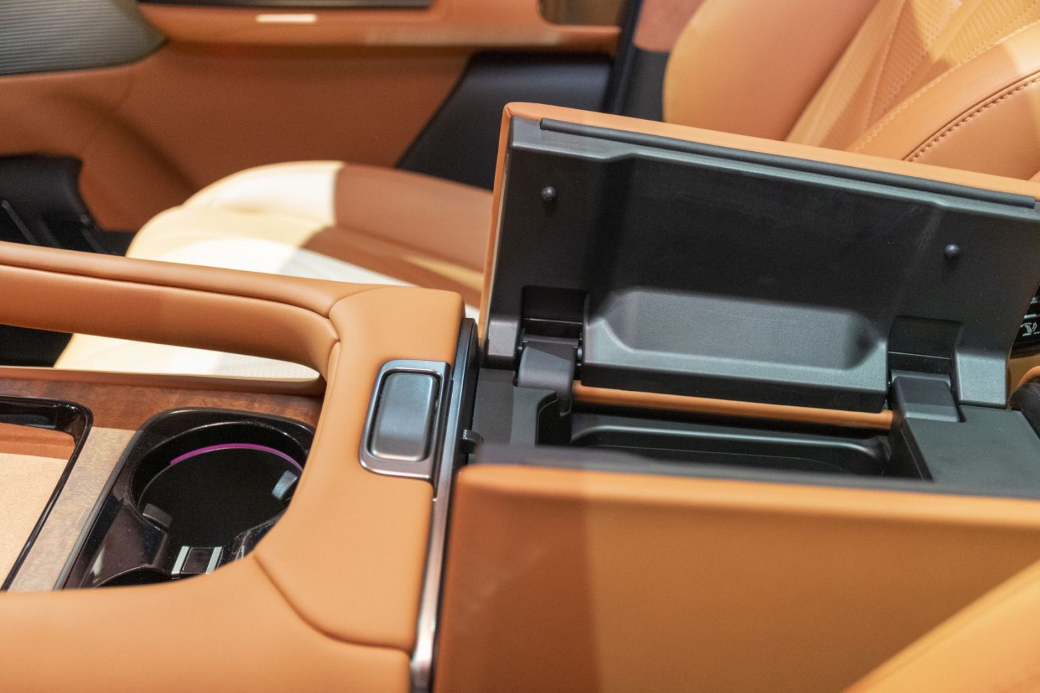 Premium brown leather center console with open storage compartment