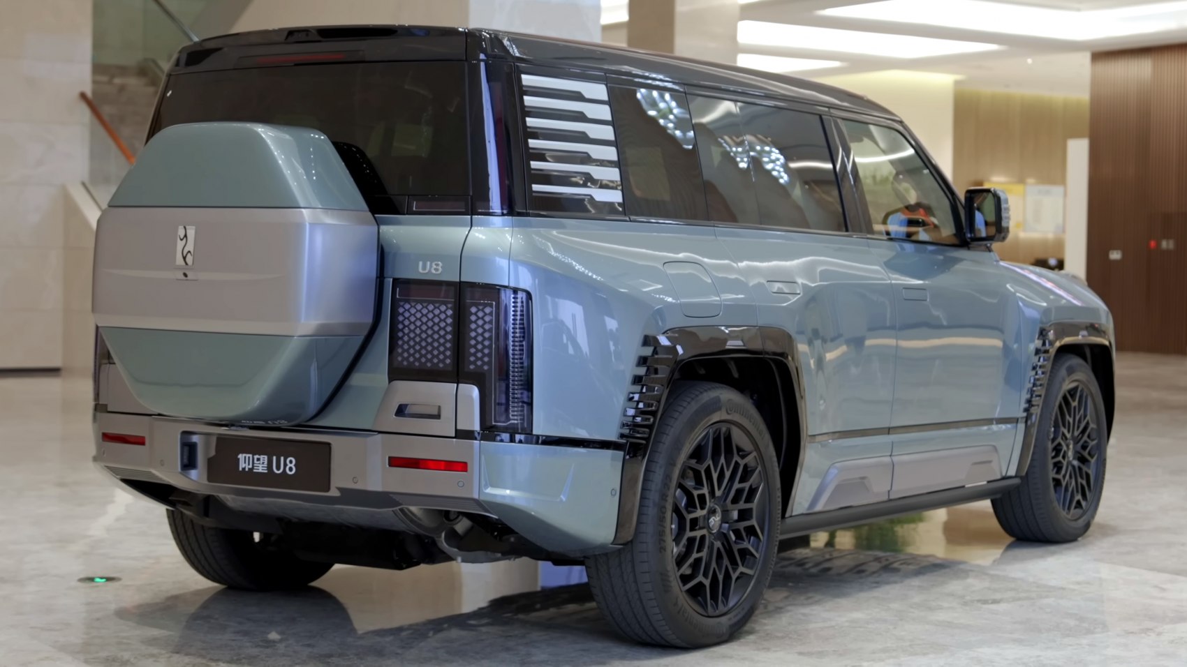 Rear and side profile of an SUV with spare tire cover and unique taillights