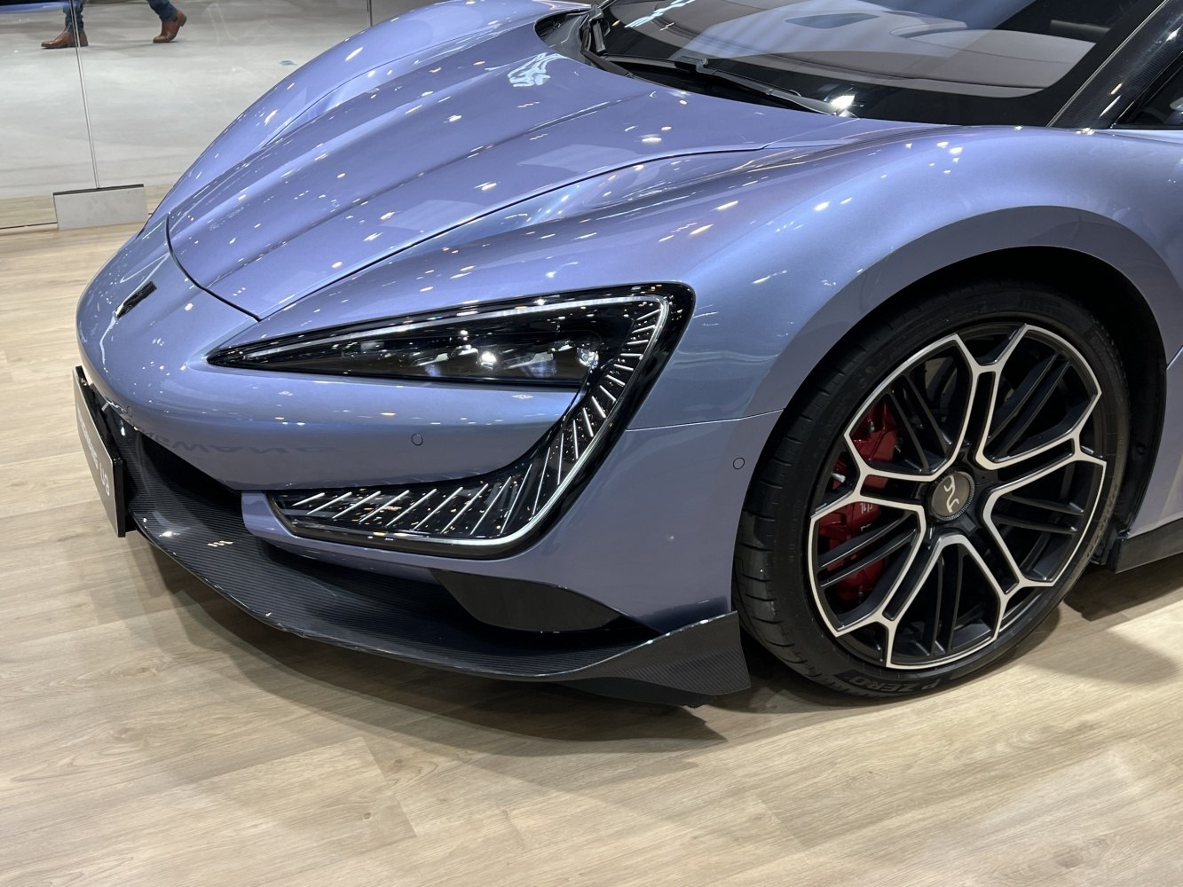 Sleek front headlights and aerodynamic alloy wheel with red brake caliper
