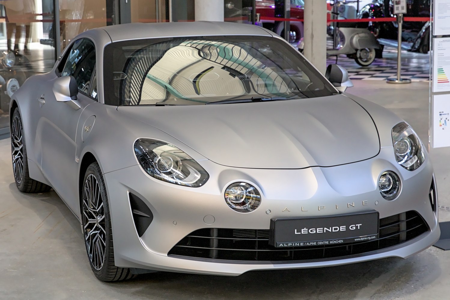 Sporty coupe front with dual round fog lights and aerodynamic body.