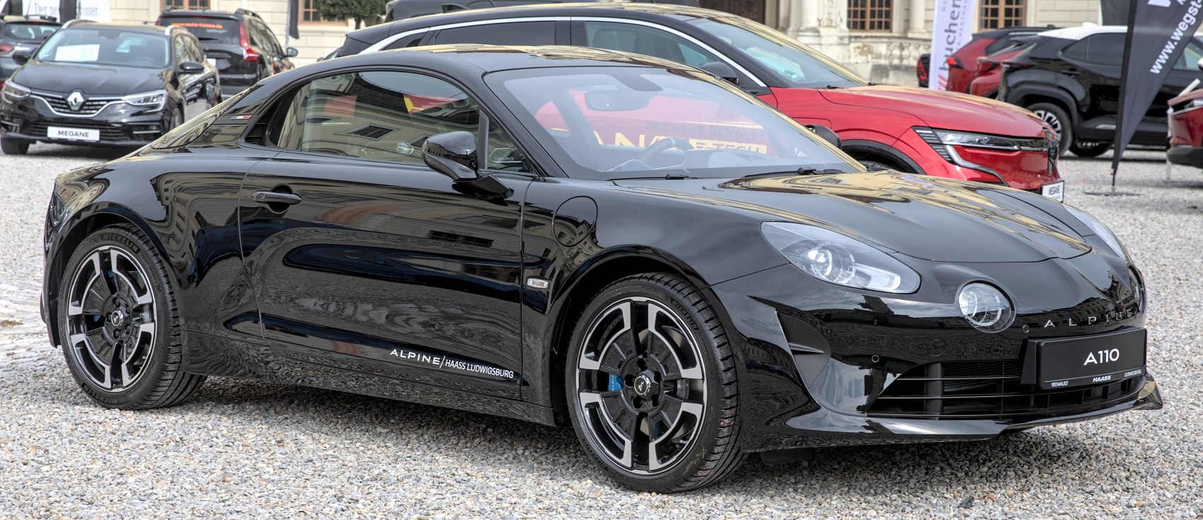 Sleek black sports coupe with unique front headlights and aerodynamic side profile