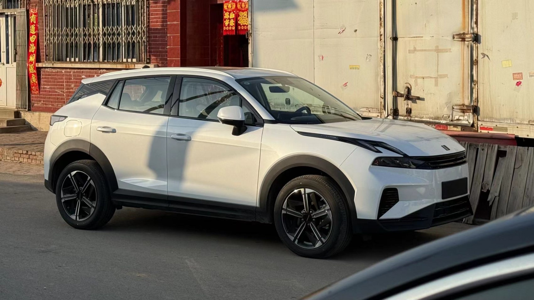 White compact SUV with black alloy wheels and futuristic front design