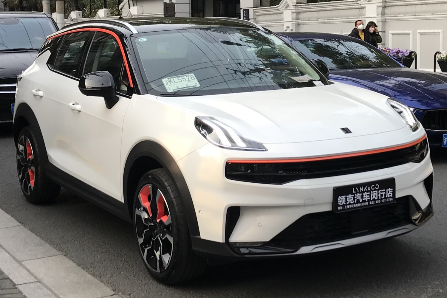 Futuristic front LED headlights with orange accent strip and stylish wheels.