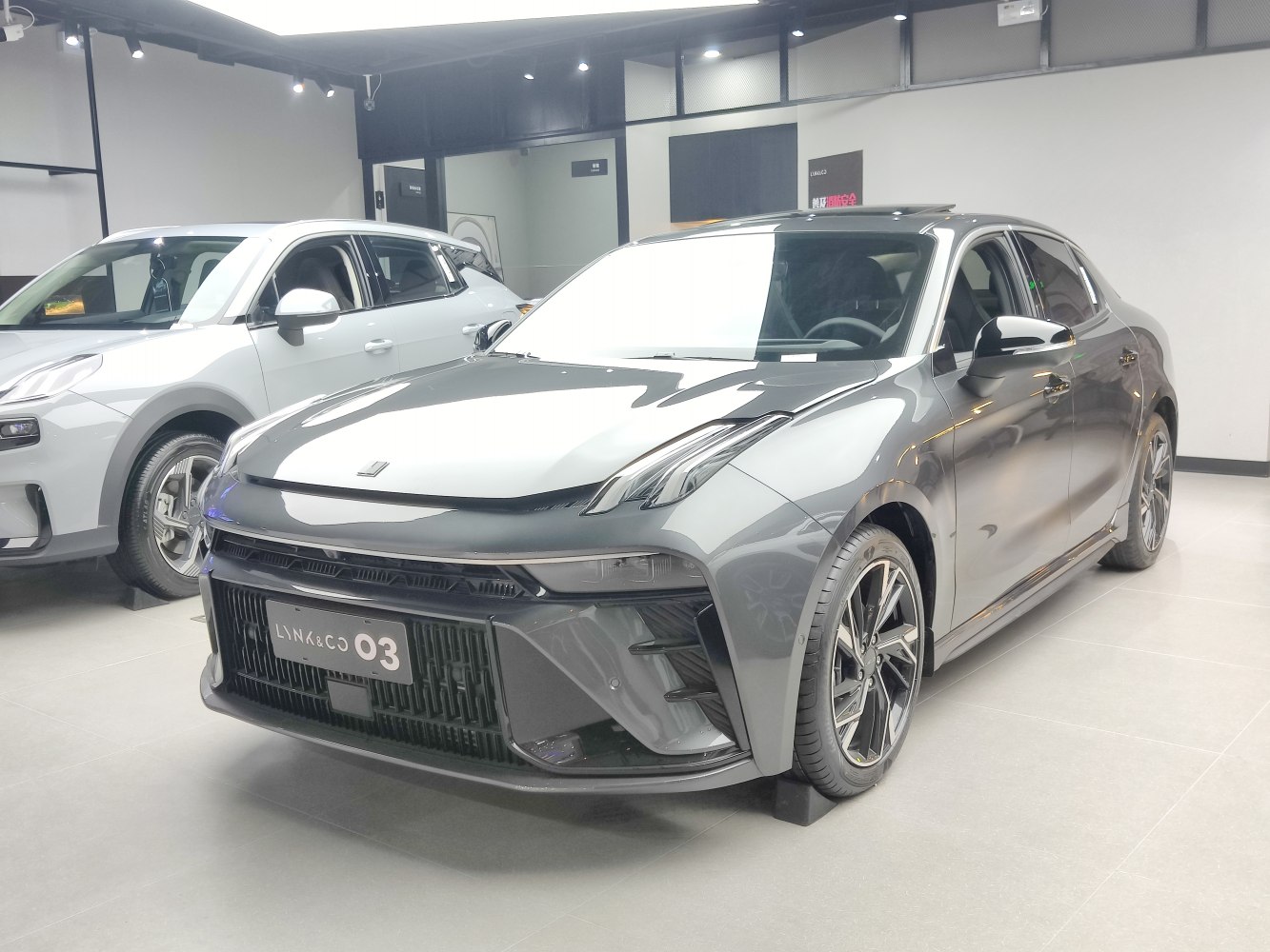 Front and side view of a sleek sedan with modern headlights and alloy wheels