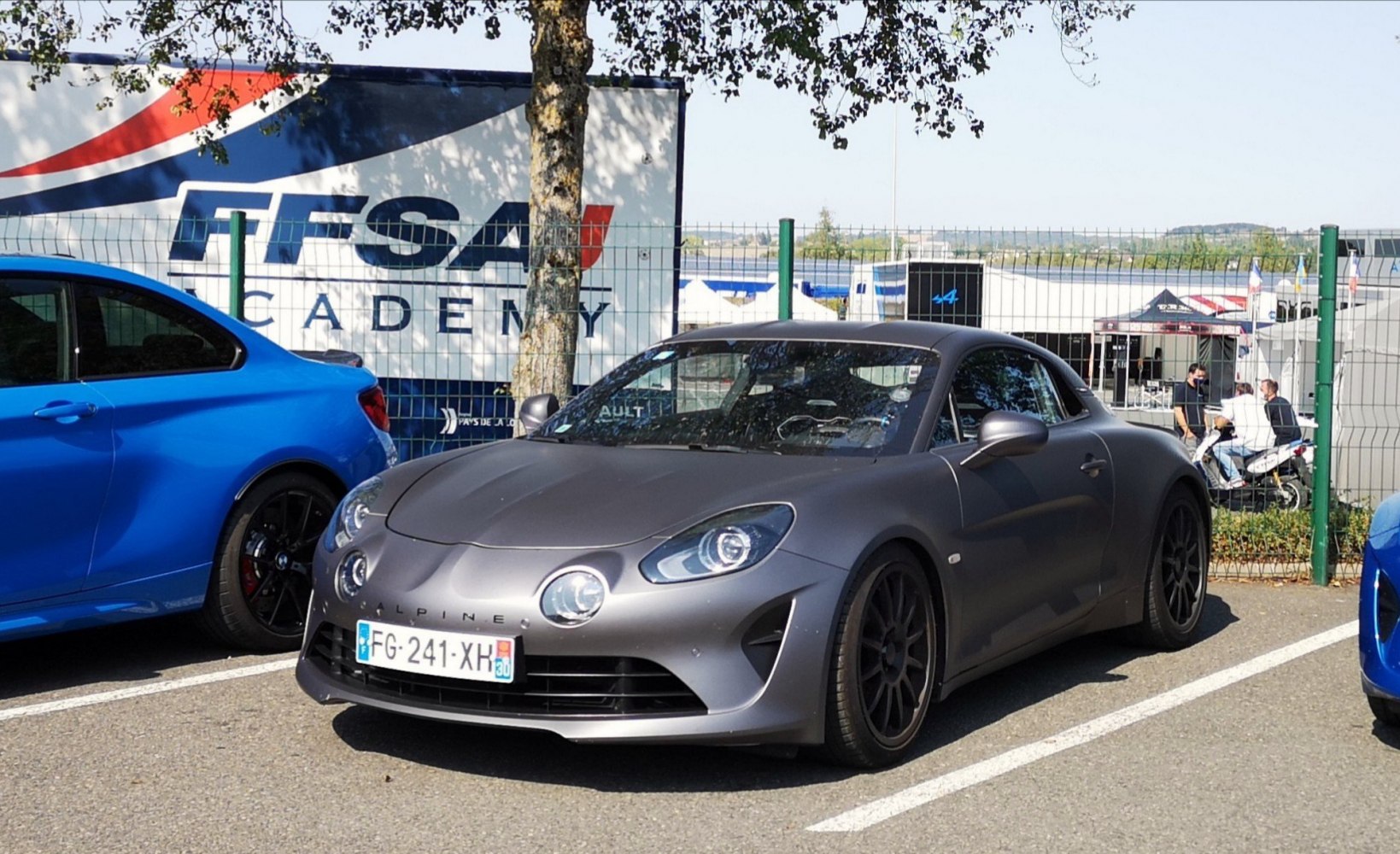Front view with round LED headlights and matte grey finish