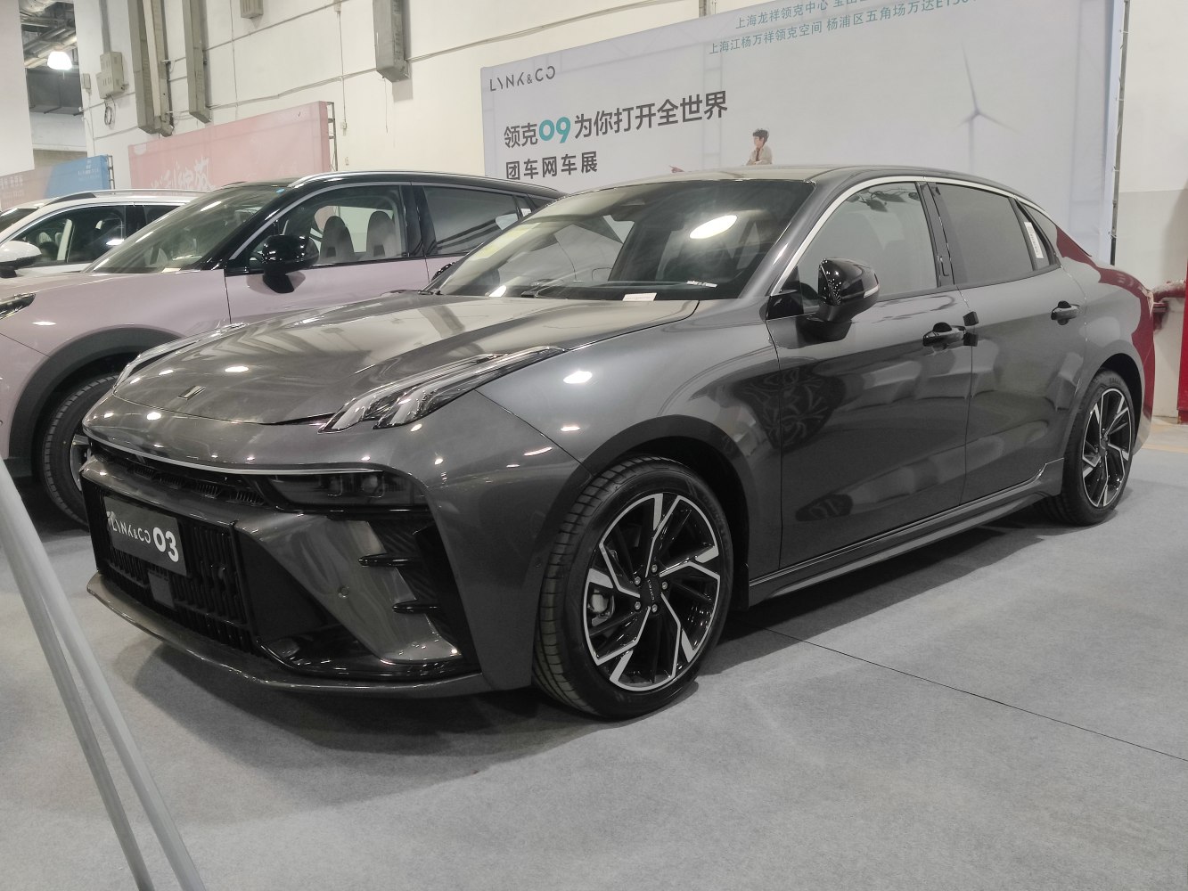 Sports sedan with sharp front lights and multi-spoke alloy wheels