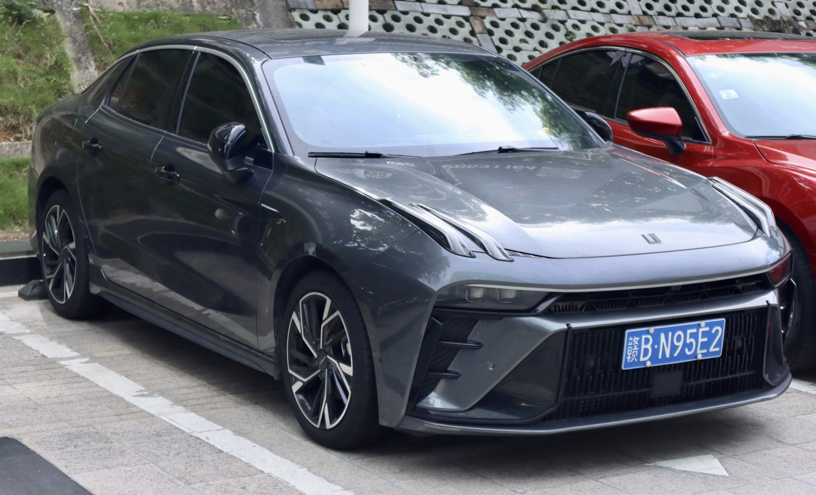 Front fascia with sleek headlights and aggressive grille of a modern sedan