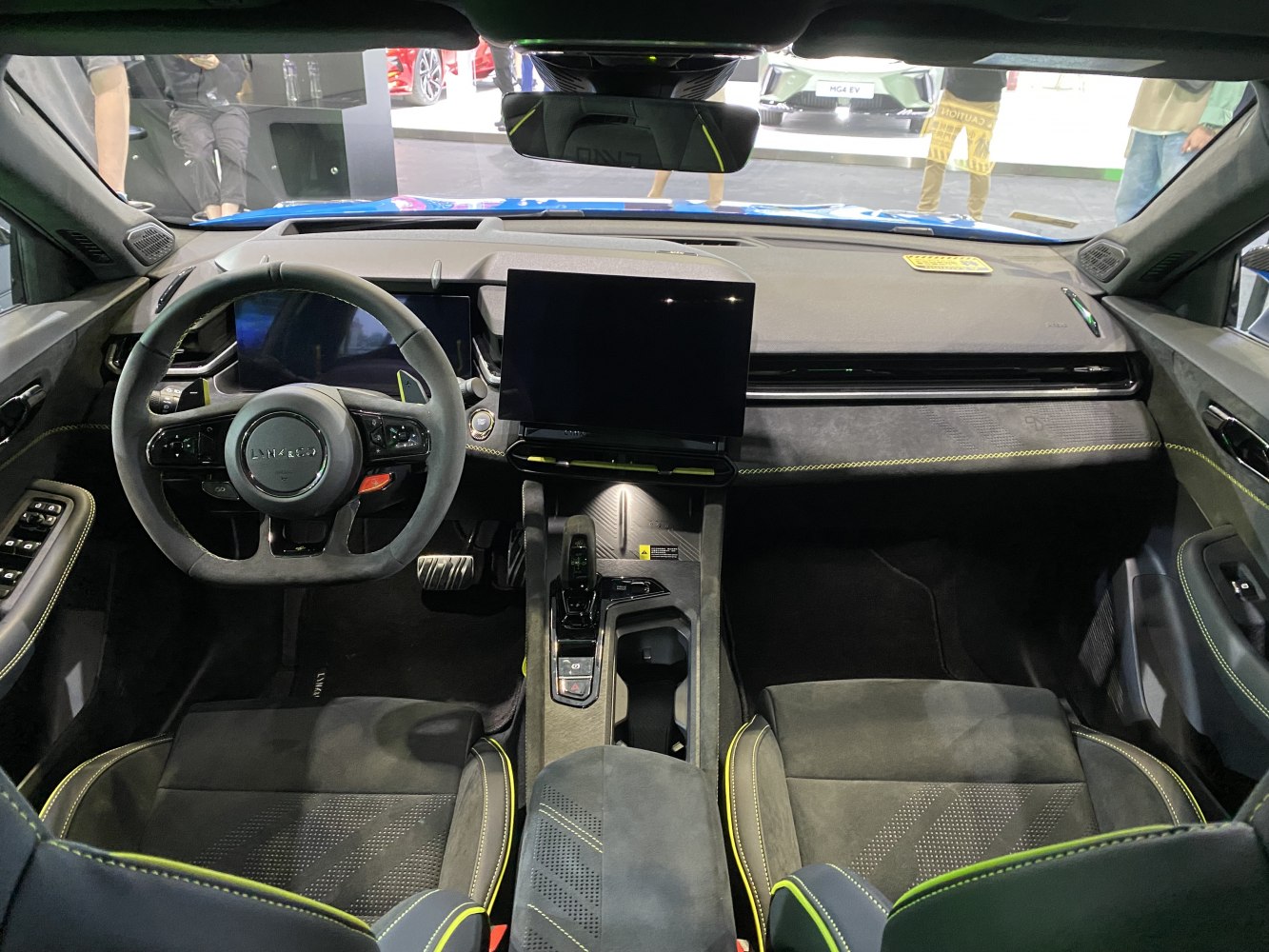 Car dashboard with digital cluster and touchscreen, sporty steering wheel, detailed center console.