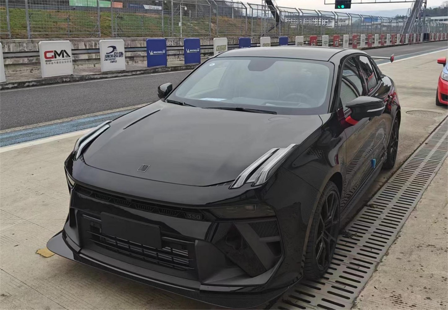 Vertical LED headlights and aggressive front bumper design on a sporty sedan.
