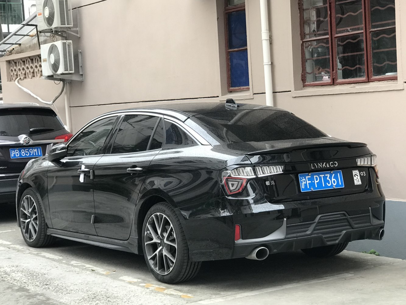 Sporty black sedan rear and side view with LED taillights and dual exhaust
