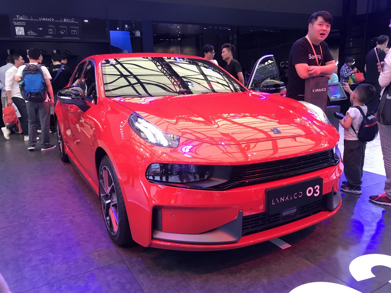 Front view of red hatchback with LED headlights and sporty grille