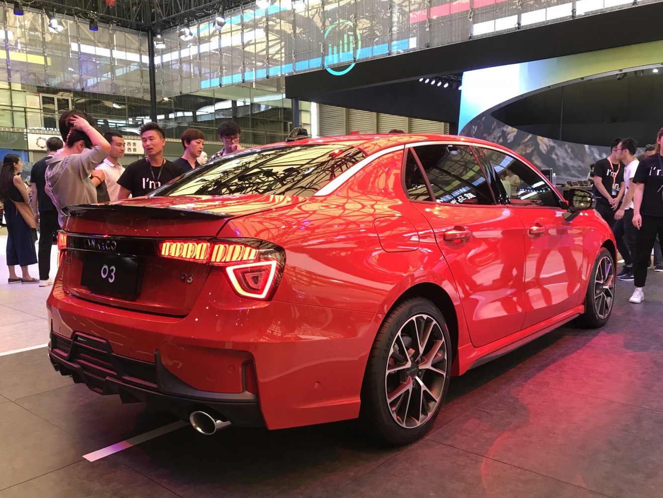 Sporty rear of red sedan with LED tailights and diffuser
