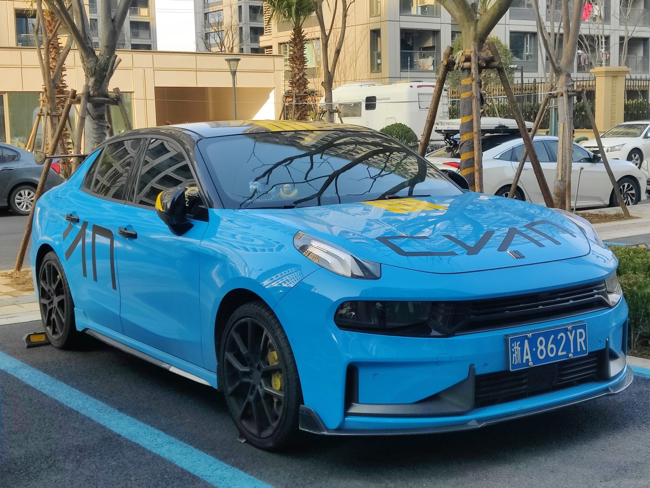 Bright blue sedan with black wheels and tinted windows