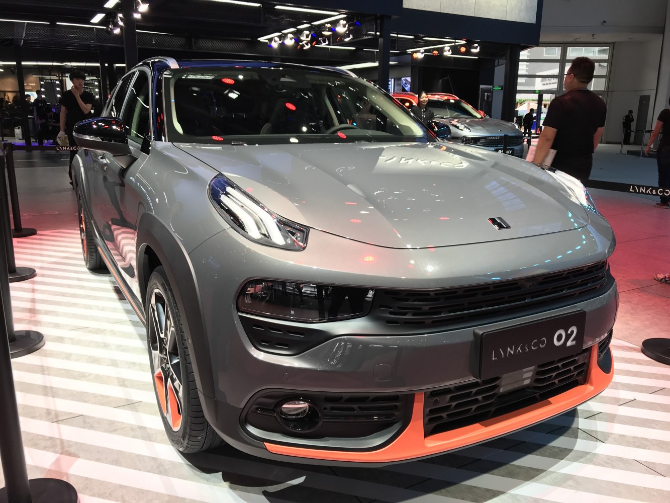 Split headlight design and distinctive grille with orange bumper accents