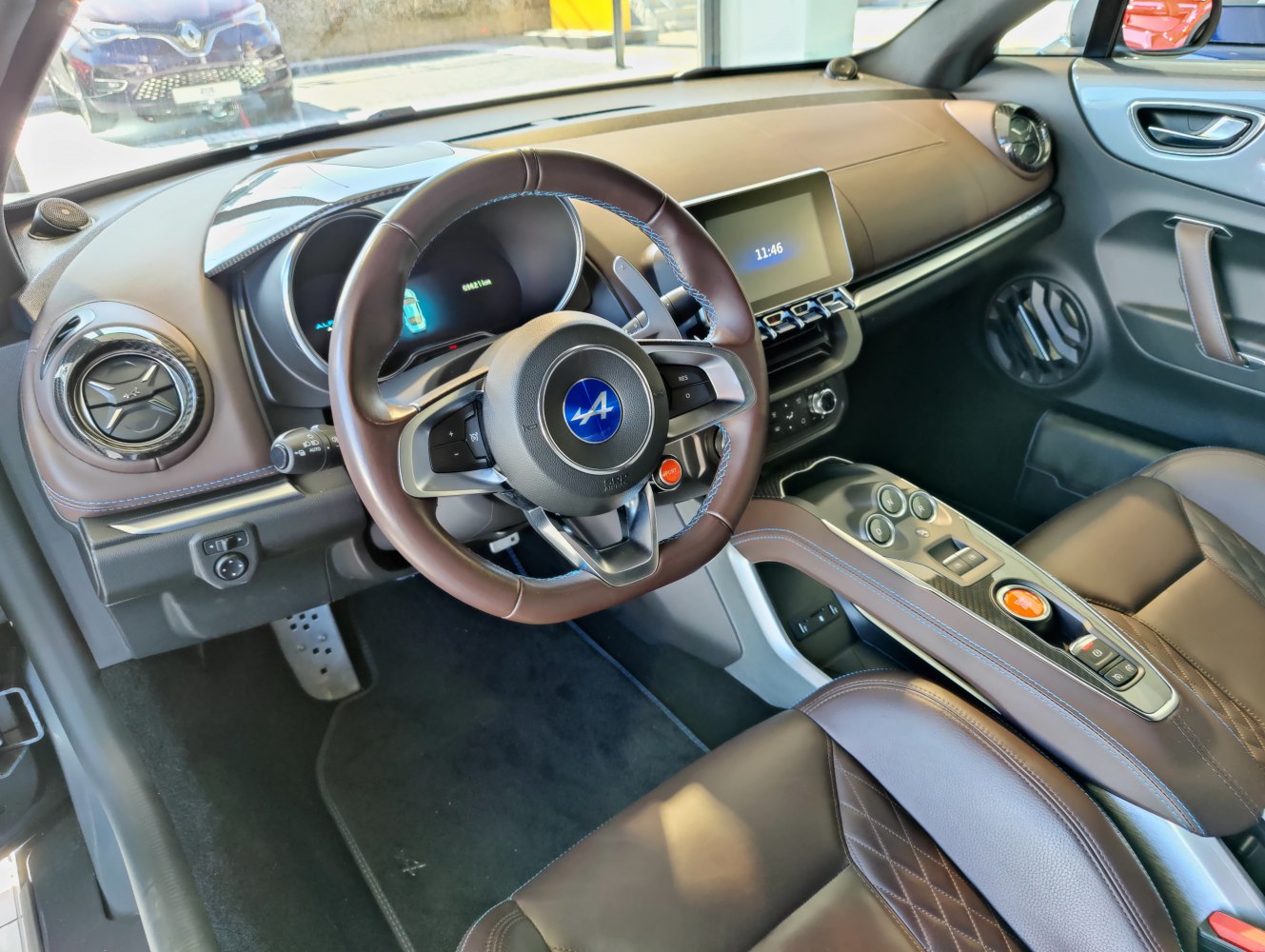 Leather steering wheel and digital dashboard in car interior